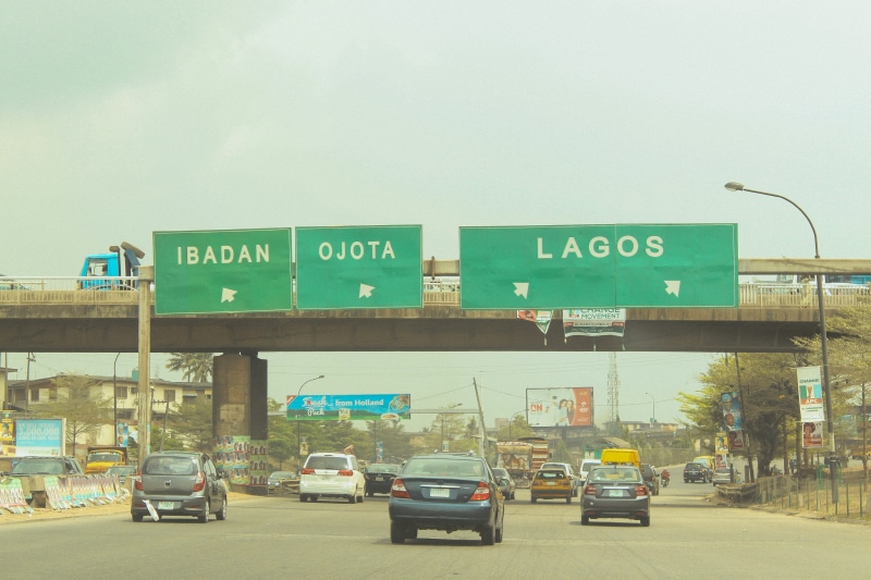 communication, transportation, road, road sign, sign, day, architecture, cars, sky, western script, script, built structure, ibadan, car, 4K, lagos, text