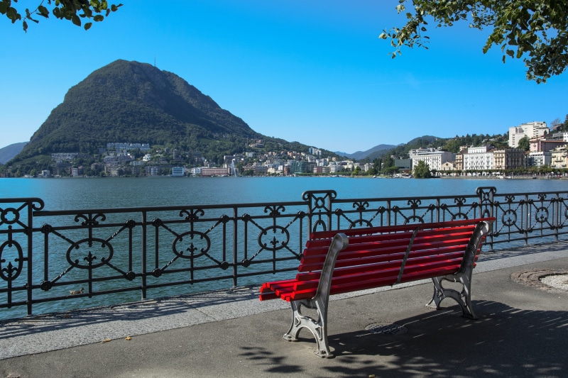 no people, sea, building, blue, frame, architecture, mountain, built structure, white, bench, day, outdoors, seat, ticino, lake lugano, southern switzerland