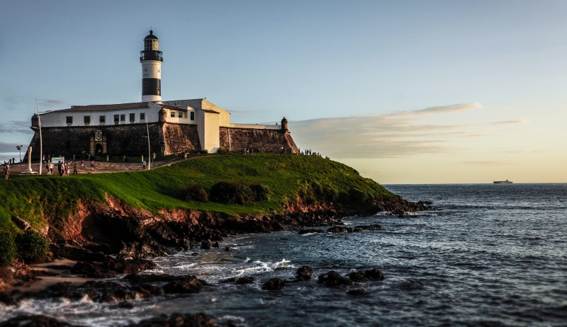 waterfront, no people, place of worship, nature, salvador, rock, beach, built structure, plant, beauty in nature, sunset, building, building exterior, location