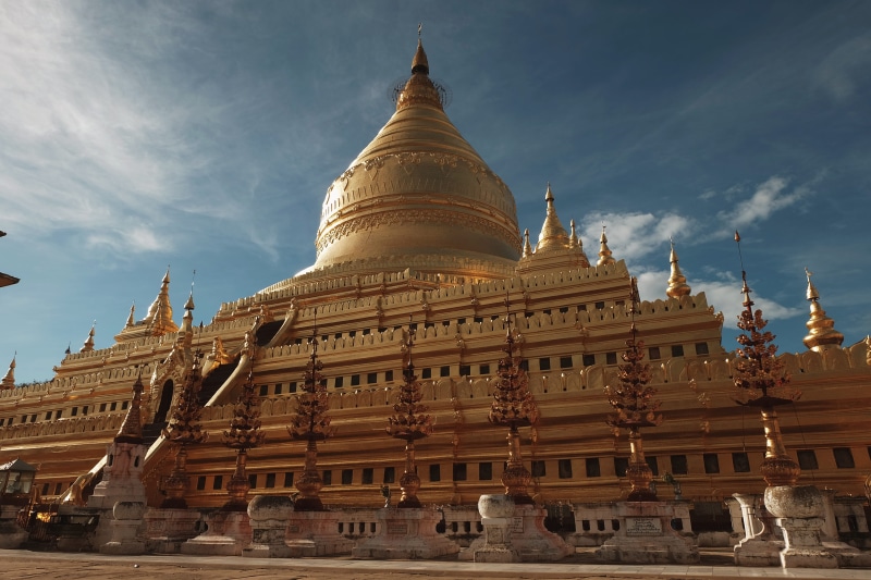 no people, outdoors, history, travel destinations, spire, low angle view, place of worship, sky, belief, myanmar (burma), old bagan, shwezigon, built structure