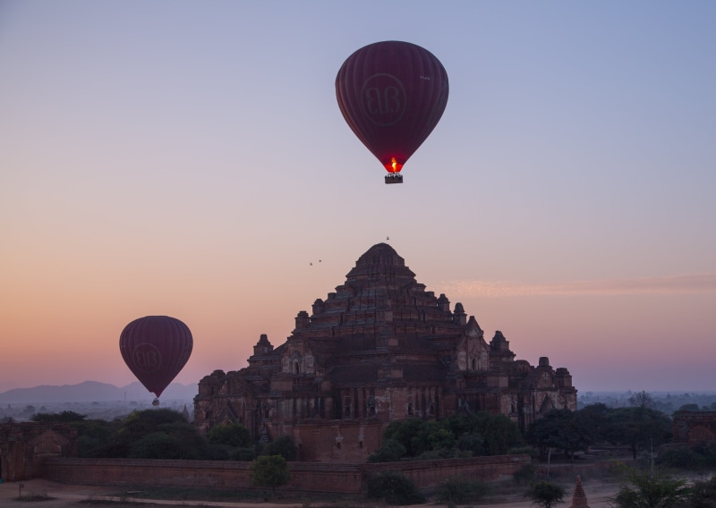 air vehicle, sunset, belief, religion, built structure, travel, travel destinations, place of worship, mid-air, sky, landscape, architecture, no people