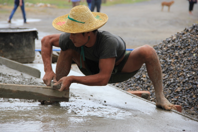 adults only, outdoors, one person, one woman only, real people, leisure activity, construction, three quarter length, day, mandalay, hat, looking down