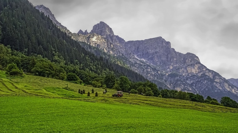 mountain range, green, Austria, grass, no people, field, nature, vehicle, mountain peak, mountains, outdoors, Tyrol, tranquil scene, Alps, cloud - sky