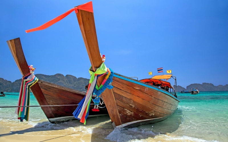 clear sky, blue, day, land, moored, beach, sea, boat, water, scenics - nature, mode of transportation, sky, canoes, brown, two, outdoors, nature, wooden