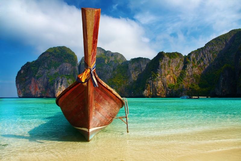 beauty in nature, mountain, no people, rock, mountain peak, nautical vessel, longtail boat, sky, tranquility, mode of transportation, cloud - sky, turquoise colored