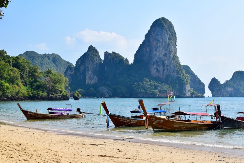 rock, tranquility, scenics - nature, railay beach, tranquil scene, mountain range, mountain, mode of transportation, land, nautical vessel, sky, mountain peak