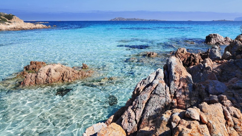 beauty in nature, idyllic, shore, rocky coastline, land, day, coast, tranquility, italy, beach, ocean, rock, outdoors, porto cervo, nature, blue sea, tranquil scene