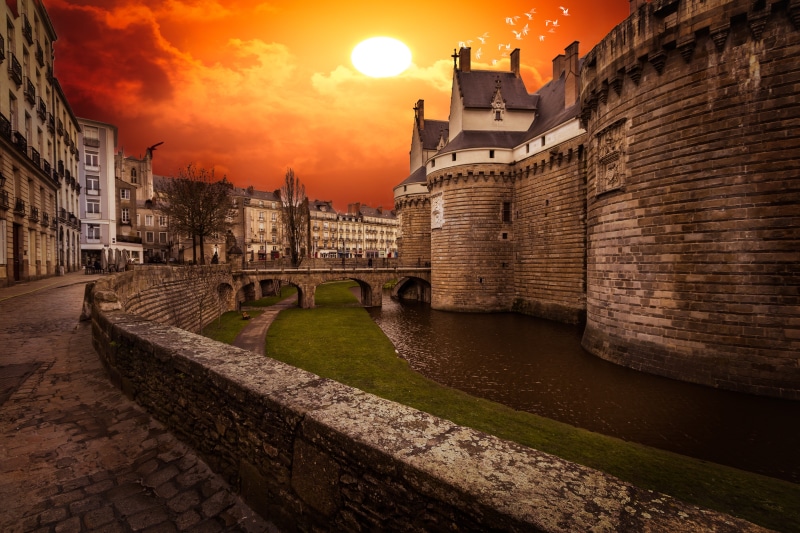 arch bridge, outdoors, castle, sky, france, connection, built structure, travel, bridge, colors, water, travel destinations, evening, history, grand, sunset