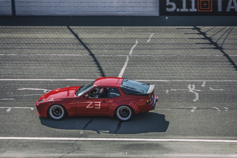 road marking, city, high angle view, porsche 944, land vehicle, marking, 5K, motor vehicle, mode of transportation, text, transportation, red, toy car