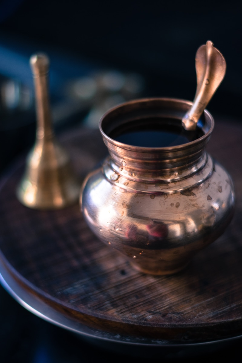 studio shot, small, pot, mahadev, oil lamp, ghanti, pooja, bell, 5K, brass, black background, table, wood - material, wood, hindu, heat - temperature