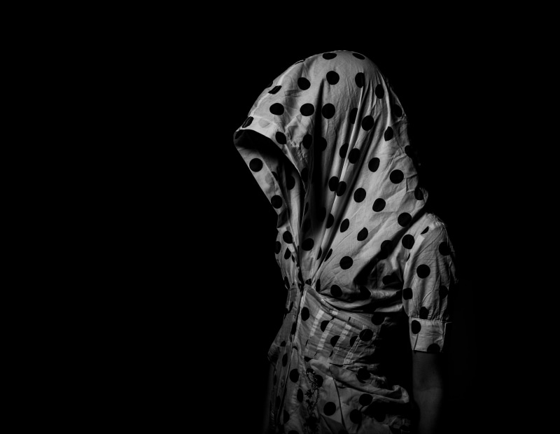 studio shot, white, front view, hooded, fine arts, short, light, clothing, obscured face, fashion, indoors, black background, dead, human, one person, horror