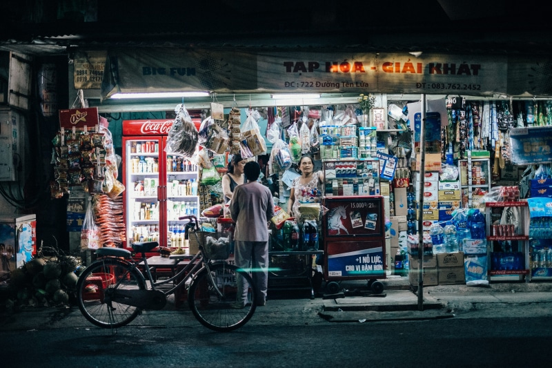 standing, land vehicle, person, people, store, retail display, At Night, market stall, city Life, city, asia, Shop, market, bicycle, architecture, small business