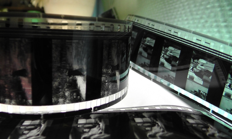 old, 35mm film, home movies, soundtrack, close-up, glass - material, film, coil, metal, reflection, transparent, indoors, cast, perforations, collection