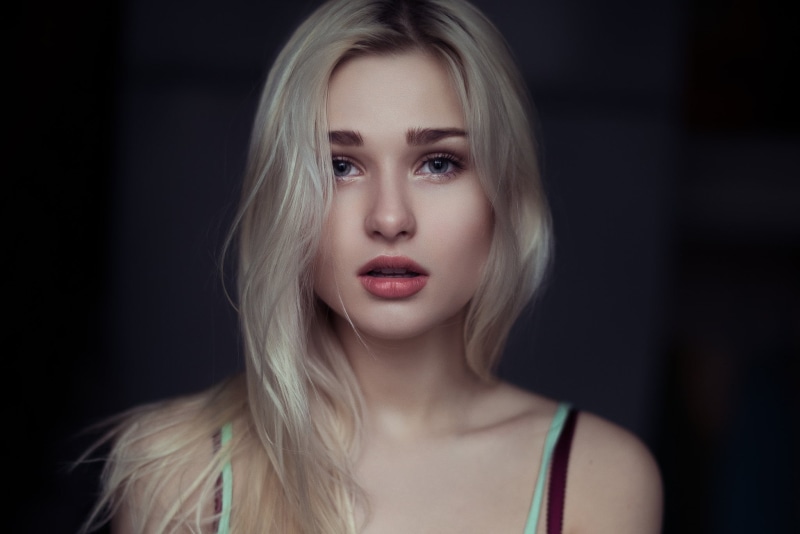 looking at camera, blond hair, black background, beautiful woman, hairstyle, adult, hair, contemplation, women, blonde, studio shot, beauty, mouth open