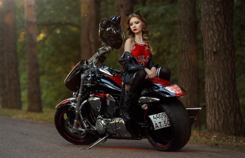 mode of transportation, depth of field, motorcycle, hairstyle, lifestyles, brunette, thigh-highs, boots, road, real people, biker, tree, looking at camera