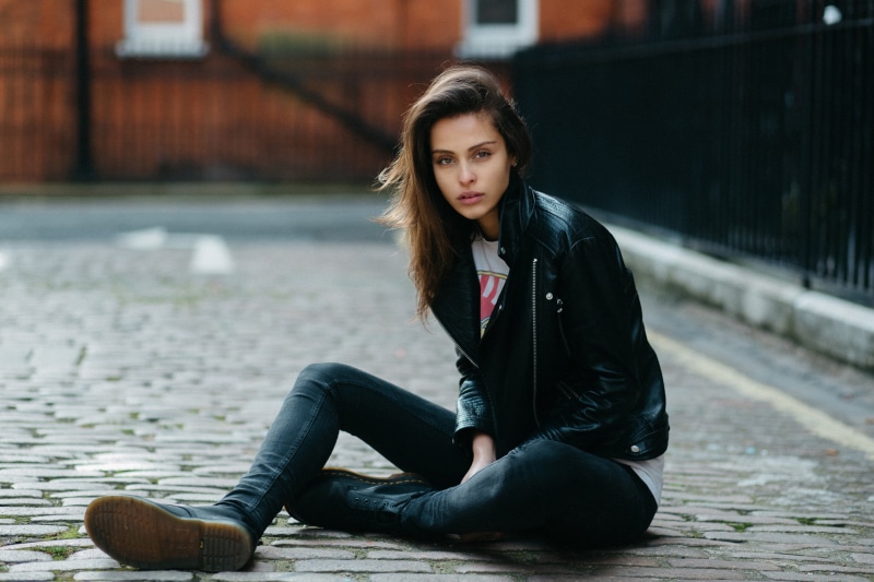 architecture, leather jackets, leisure activity, beauty, open mouth, social issues, hair, looking at camera, contemplation, long hair, leather, outdoors