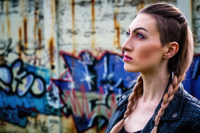 rock, adults only, real people, train, young adult, focus on foreground, contemplation, person, fashion, casual clothing, riddle, hairstyle, one person