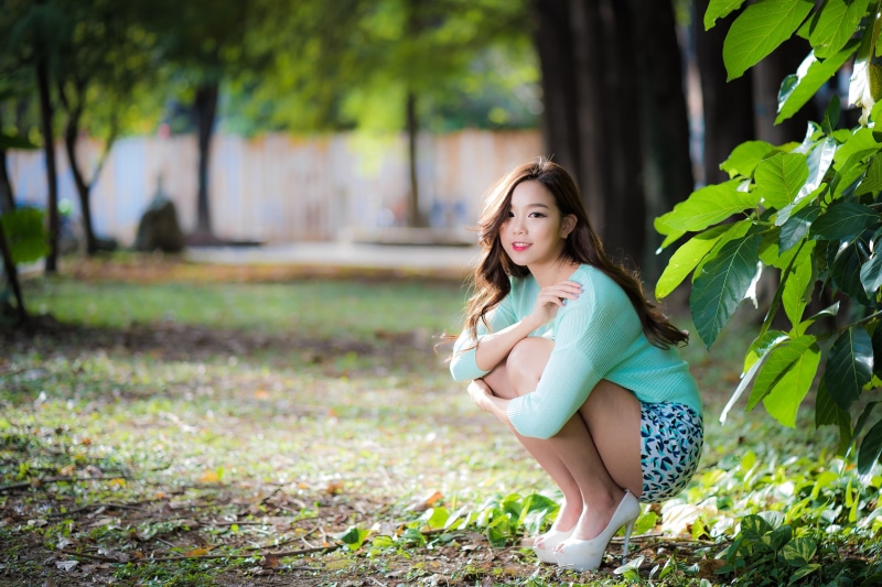looking at viewer, short shorts, full length, outdoors, fashion, dress, leisure activity, women outdoors, smiling, women, Asian, hairstyle, depth of field