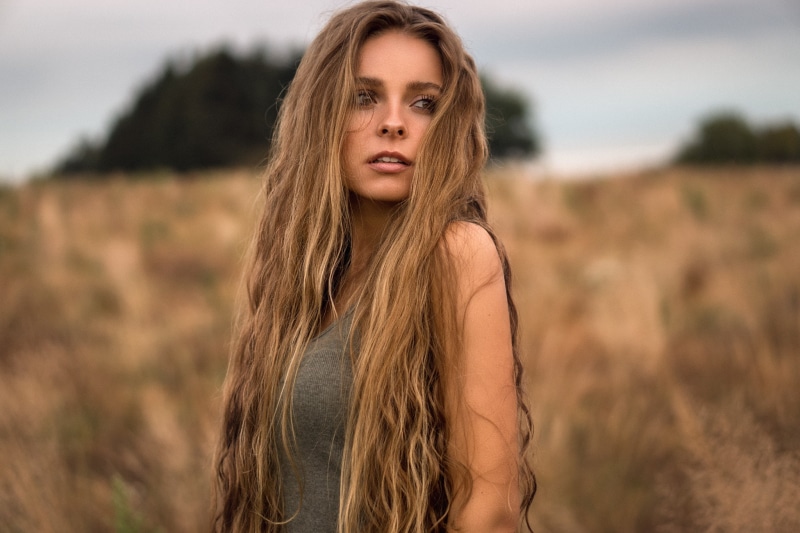 beauty, teenager, hair in face, contemplation, land, blond hair, one person, open mouth, looking at camera, 1080P, hair, adolescence, landscape, adult