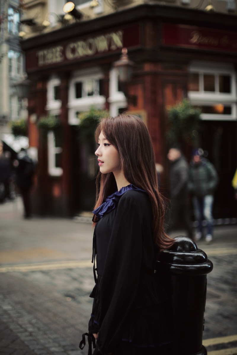 young women, contemplation, standing, LOONA, hair, real people, K-pop, focus on foreground, lifestyles, architecture, young adult, beauty, building exterior