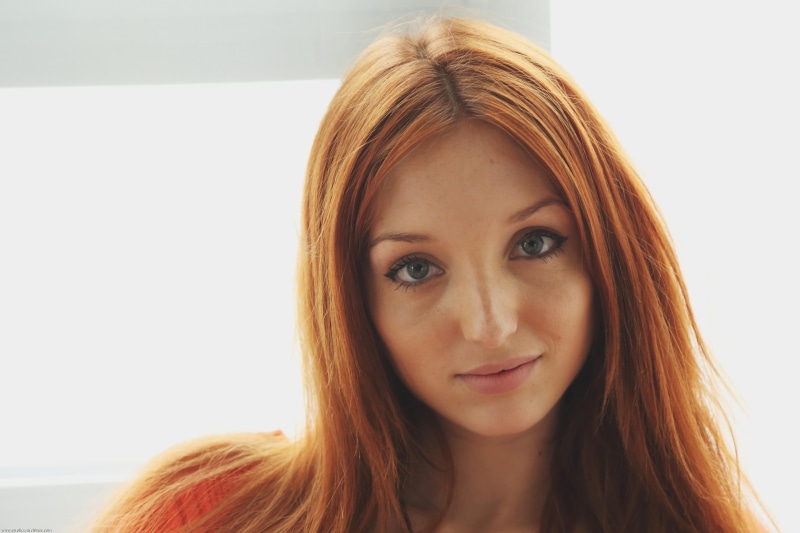 looking at camera, close-up, hairstyle, hair, portrait, brown hair, orange, young adult, one person, redhead, headshot, face, woman, top, adult, human face