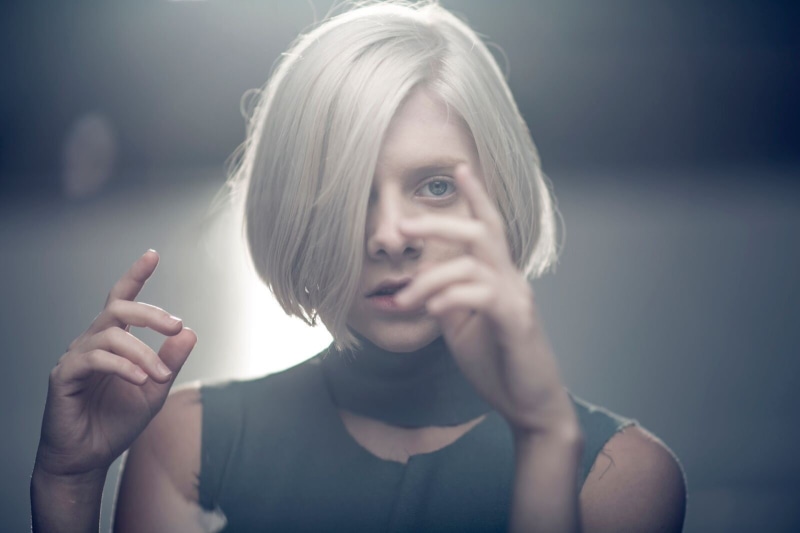 holding, beautiful woman, hairstyle, looking at camera, eyes, platinum blonde, 720P, blue eyes, studio shot, young women, one person, white hair, indoors