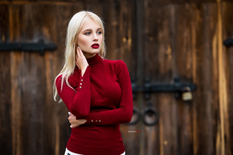 red lipstick, Maksim Romanov, pale, Maks Romanov, blue eyes, blonde, model, platinum blonde, red sweater, 2K, long hair, women, looking into the distance