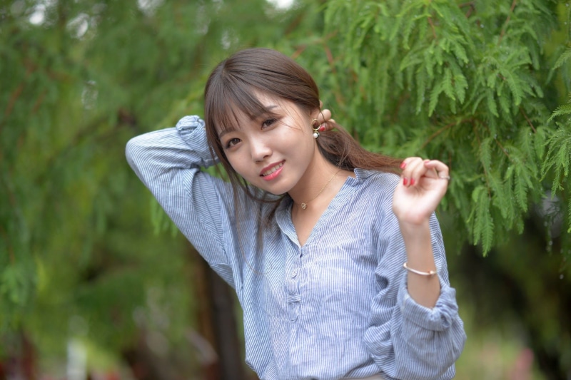 brunette, smiling, 1080P, Asian, pearl earrings, hands in hair, women outdoors, striped clothing, women