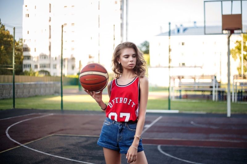 depth of field, model, one person, basketball court, shorts, sports jerseys, three quarter length, lifestyles, sport, standing, childhood, hair, pearl earrings