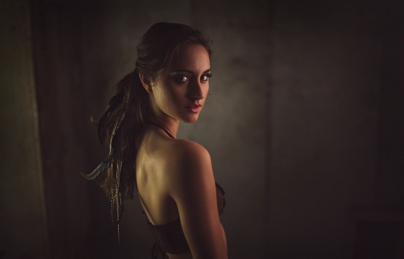 glamour, indoors, bare shoulders, dark, back, standing, long hair, looking, simple background, fashion, women, copy space, beautiful people, contemplation