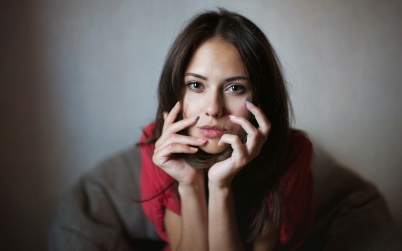 looking at camera, indoors, face, front view, one person, head in hands, contemplation, 500px, hand, portrait, emotion, body part, beautiful woman, young adult