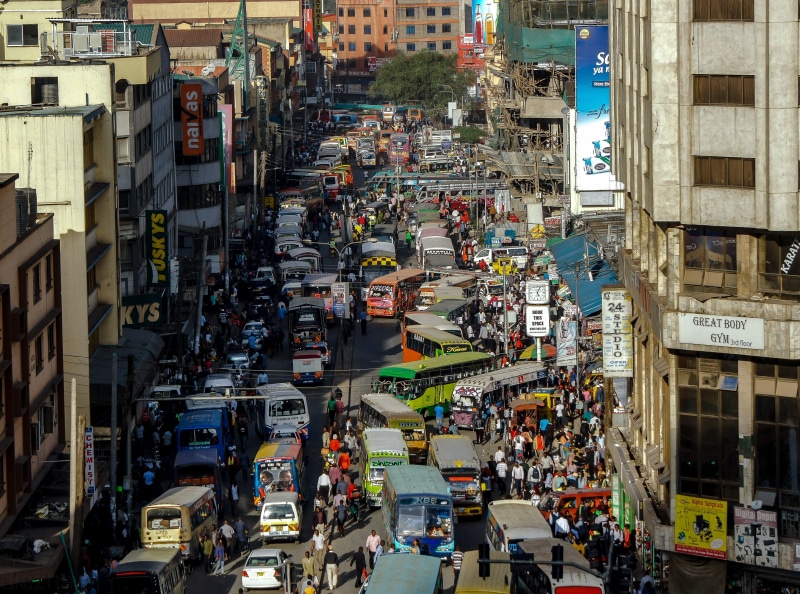 car, city street, district, crowd, urban, business, large group of people, nairobi, road, streets, day, outdoors, built structure, building exterior, traffic