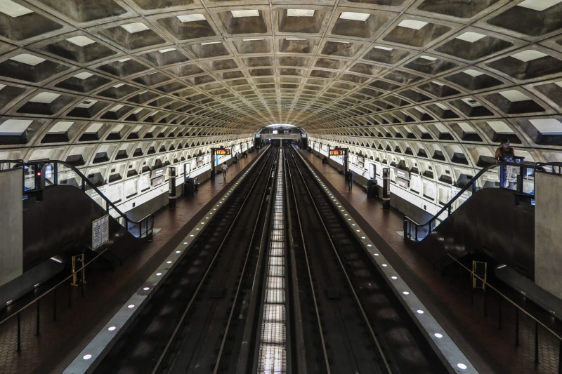 diminishing perspective, track, arched, underground, grid, transit, direction, escalator, incidental people, platforms, indoors, station, commute, public