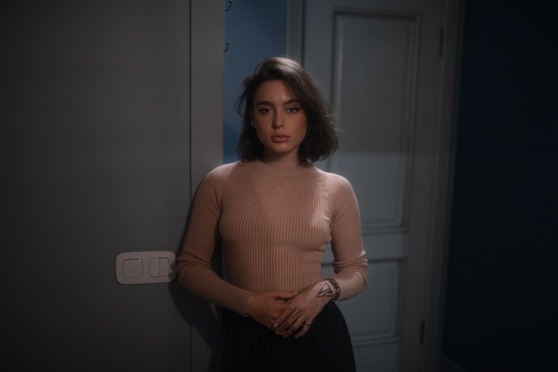 looking at viewer, women, indoors, 720P, Andrey Firsov, pierced septum, model, door, inked girls, sweater, brunette, tattoo, portrait, women indoors, pants
