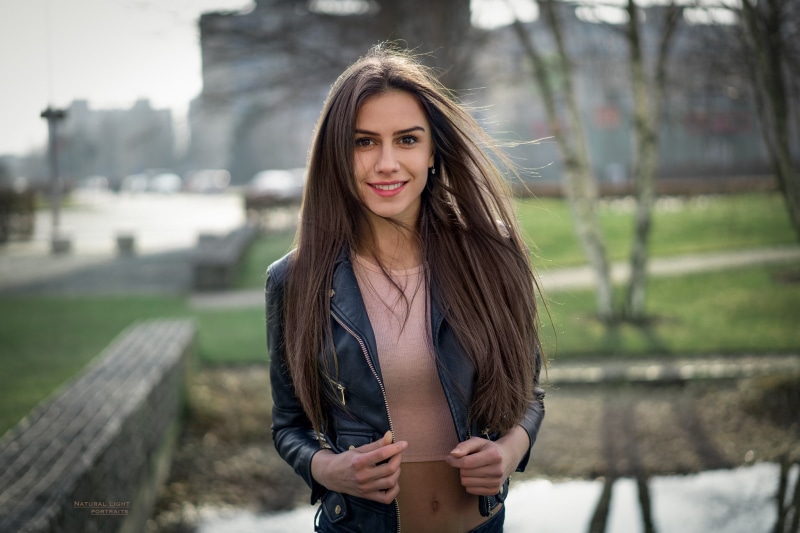 outdoors, open clothes, looking at viewer, depth of field, one person, young women, 1080P, front view, looking at camera, long hair, hazel eyes, black jackets