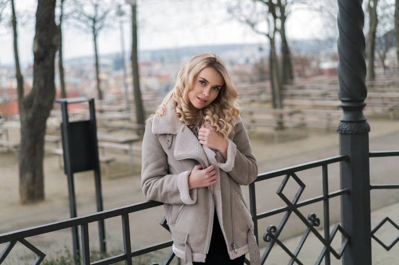 smirk, long hair, bomber jacket, blond hair, blonde, tree, coats, looking at camera, young adult, Robert Chrenka, one person, young women, lifestyles, women outdoors