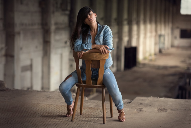 architecture, casual clothing, beautiful woman, full length, lifestyles, couple - relationship, one person, chair, women, model, hair, seat, adult, outdoors