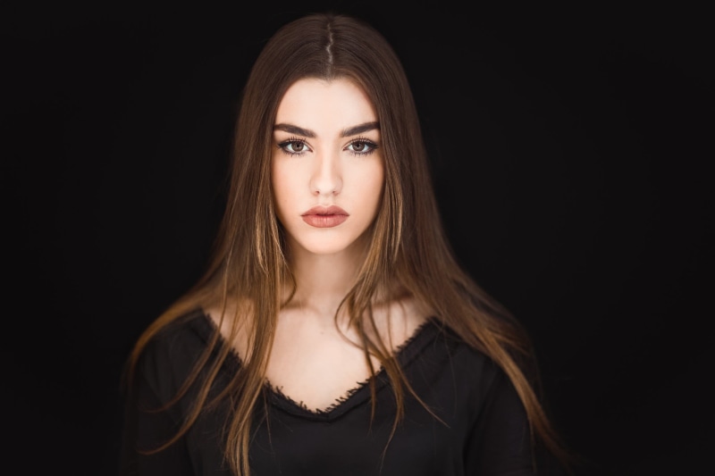cut out, portrait, indoors, straight hair, looking at camera, teenager, 1080P, simple background, young adult, brown eyes, women, contemplation, looking at viewer