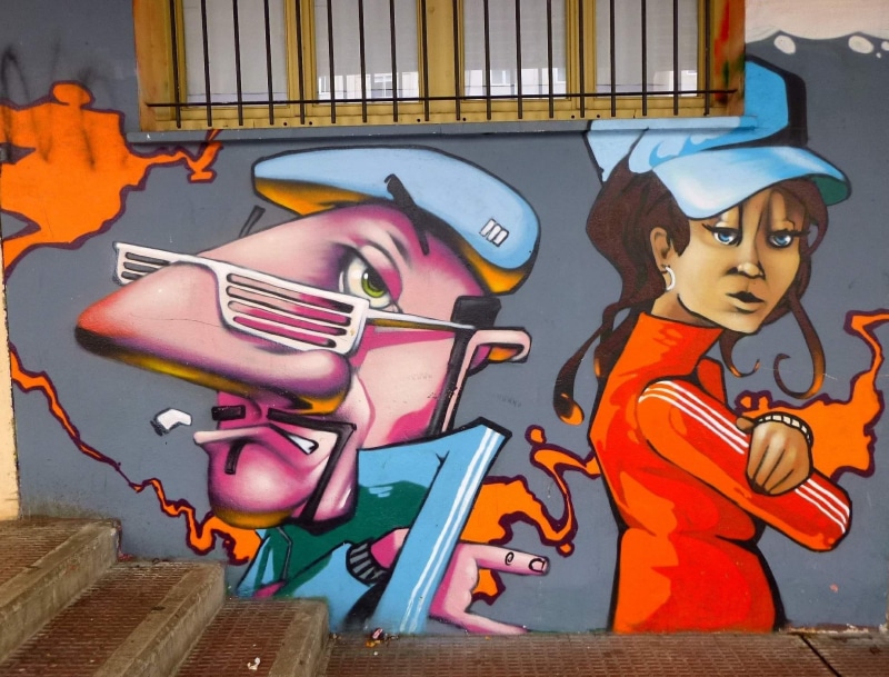 woman in red, illustration, indoors, art, eyeglasses, no people, spray paint, male likeness, stair, human representation, red jacket, outdoors, cap, navarre