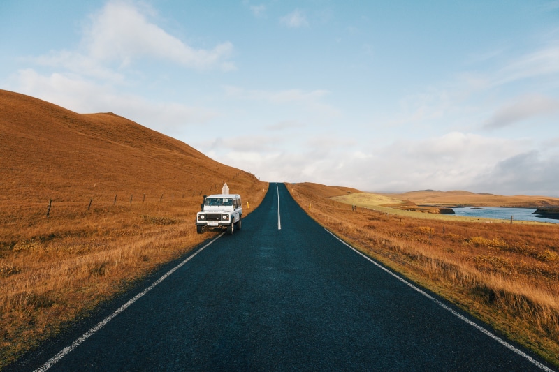 suv, day, field, scenics, transportation, grass, car, blue, the way forward, parked, road, brown, highway, diminishing perspective, cloud - sky, outdoors