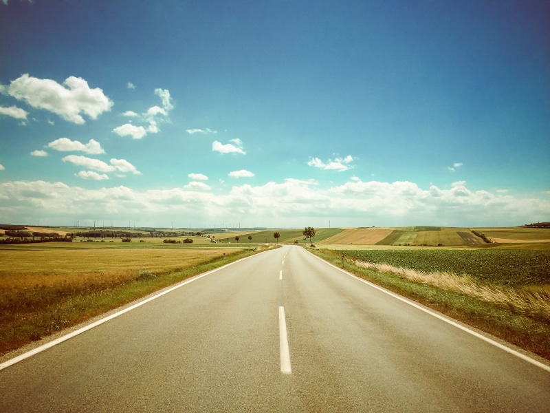 straight, sunny, no People, land, road marking, outdoors, dividing line, horizon, landscaped, rural Scene, grass, travel, asphalt, blue, the way forward