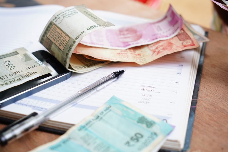 people, bank, indoors, crime, finance and economy, day, borrowing, high angle view, business person, giving, india, still life, business, bribing, global business