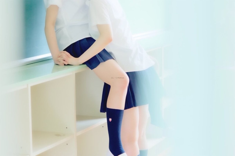 clothing, skirt, one person, sunlight, leisure activity, peeping, day, real people, legs, indoors, school uniform, obscured face, wall - building feature