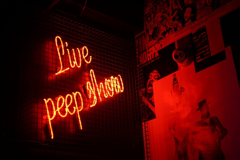 show, text, warning sign, indoors, wall, western script, communication, glow, peep, light, neon, illuminated, dark, cage, number, night, orthographic symbol