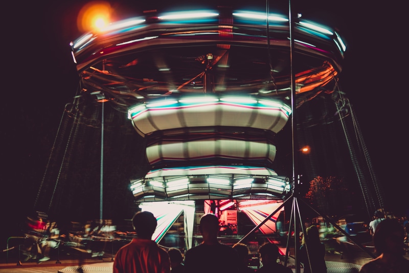 amusement park ride, real people, lifestyles, spinning, illuminated, ride, women, adult, people, time lapse, circus, medium group of people, built structure