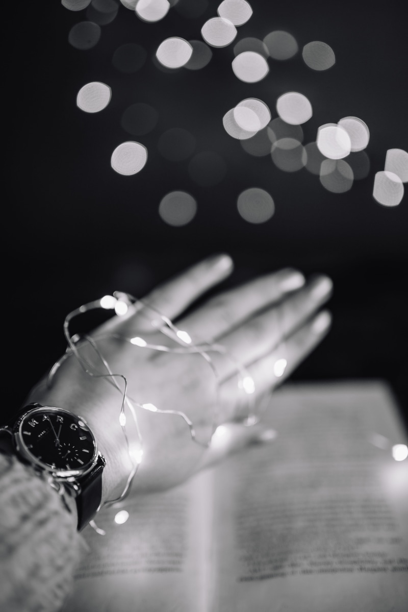 defocused, glowing, night, one person, glass, human Hand, table, light - natural phenomenon, indoors, no people, human body part, Fairy Lights, selective focus