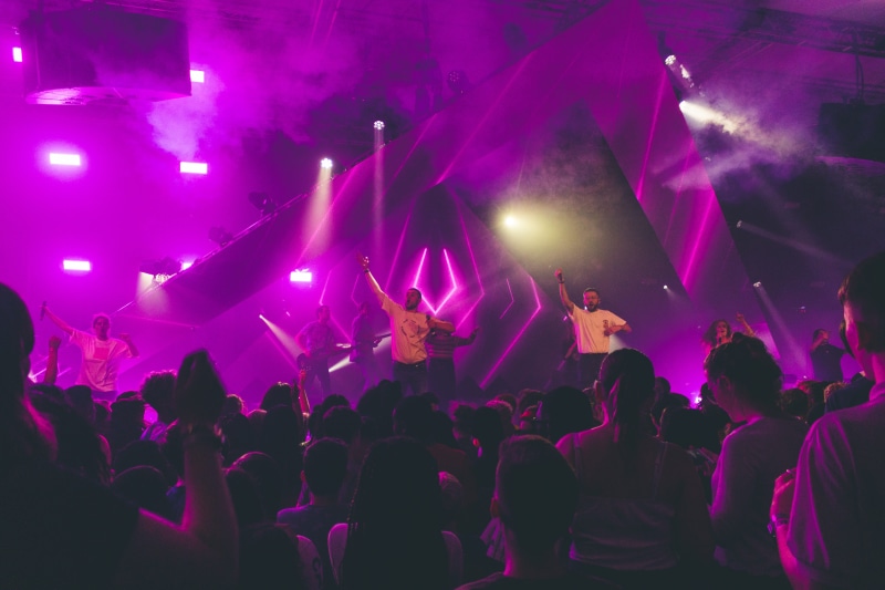 worship, night, music, illuminated, positive emotion, festival, lighting equipment, spectator, audience, men, arms raised, performance, performing, group of people