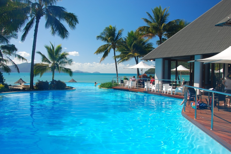 turquoise Colored, pool, palm trees, white, house, tropics, palm Tree, beach, sunlight, tourist Resort, scenics, outdoors, chair, sea, relaxation, holiday