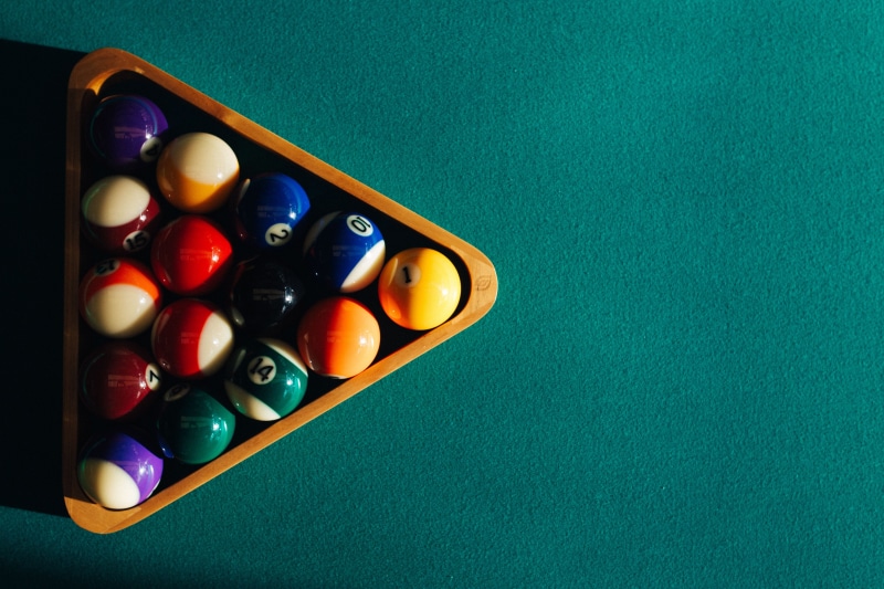 pool game, high angle view, close-up, shape, billiard cue, green, leisure games, nobody, red, time, hobby, pool ball, snooker, balls, green table, pool table