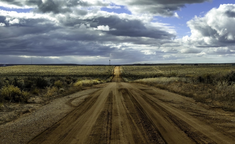 scenics - nature, the way forward, road, tranquility, beauty in nature, no people, sky, dirt, direction, outdoors, environment, rural scene, shrubs, landscape